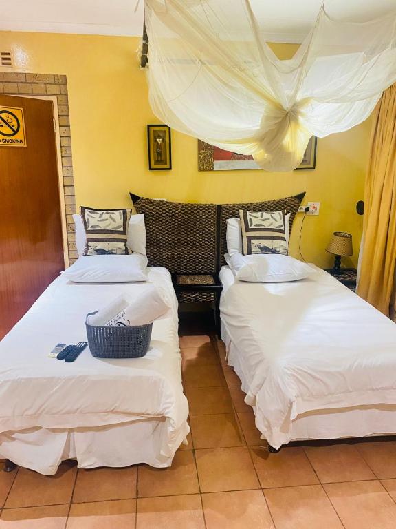Twin room with mosquito canopy and crisp white linen