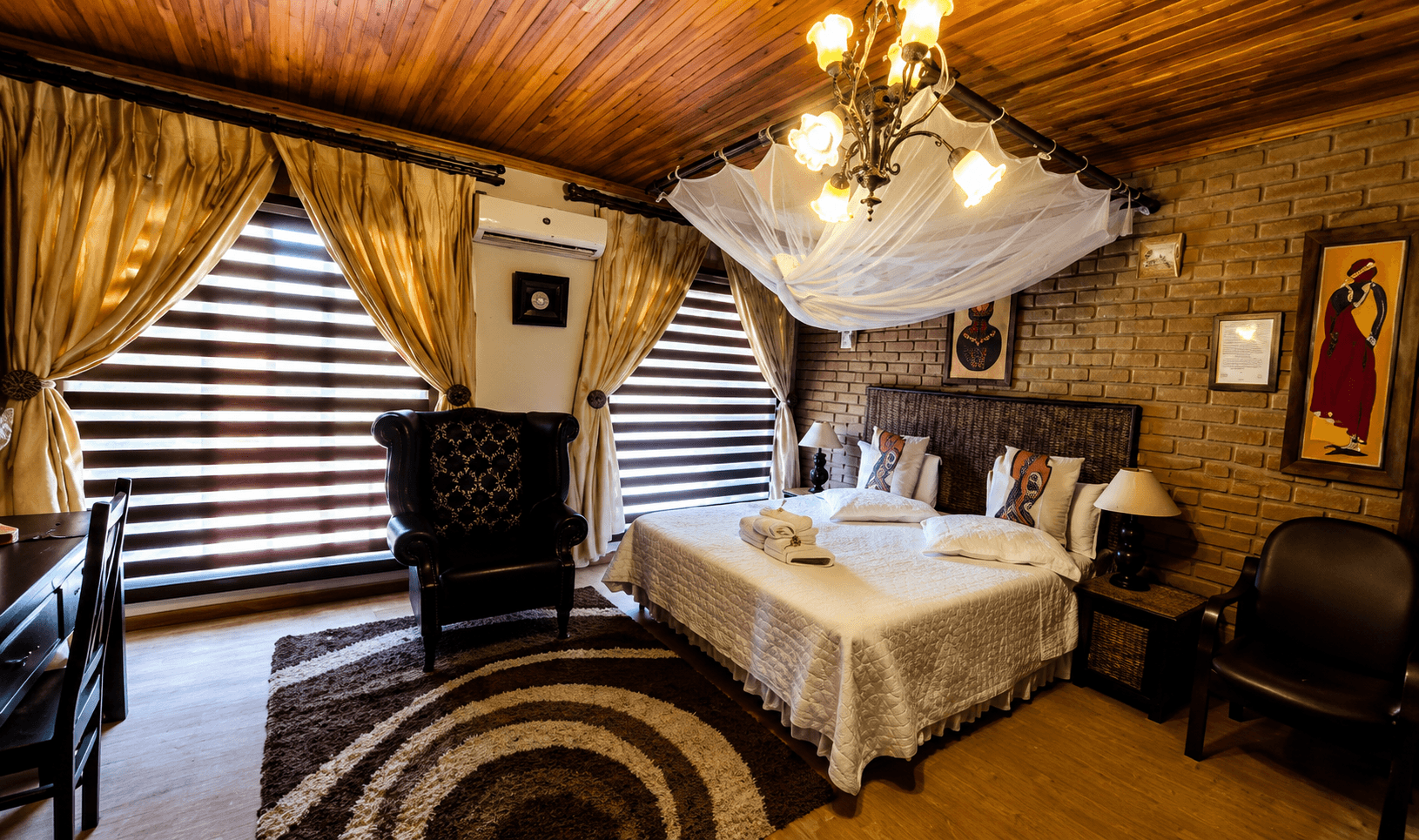 Spacious air-conditioned luxury room with African-inspired décor and crisp linen